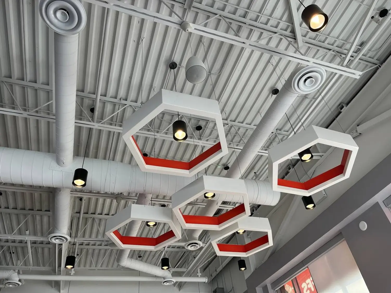 Finished Mr. Puffs café with hexagon feature lights and exposed ductwork